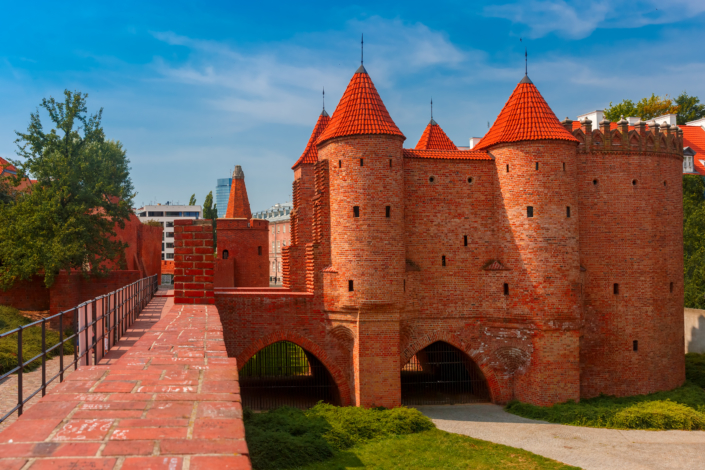 Semicircular fortified medieval outpost Barbican in the Old Town of Warsaw in the summer sunny day, Poland
